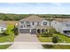 Beautiful two-story home featuring a three car garage, manicured landscaping and pond view at 2431 Knoll Dr, Apopka, FL 32712