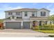 Beautiful two-story home featuring a three car garage and manicured landscaping at 2431 Knoll Dr, Apopka, FL 32712