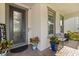 Charming front porch with a decorative front door, seating, and planters at 2431 Knoll Dr, Apopka, FL 32712
