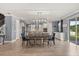 Open-concept living room and dining area with modern lighting and a fireplace feature wall, blending style with spacious comfort at 2431 Knoll Dr, Apopka, FL 32712