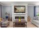 Bright living room featuring a modern fireplace, TV and comfortable seating at 2431 Knoll Dr, Apopka, FL 32712