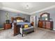 Large primary bedroom featuring a tray ceiling, wood furniture and plenty of space at 2431 Knoll Dr, Apopka, FL 32712