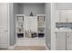 Mudroom features a built-in storage bench with shelves and decorative accents, next to laundry room at 2431 Knoll Dr, Apopka, FL 32712