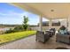 Covered brick patio featuring comfortable seating and an appealing view of the landscaped backyard at 2431 Knoll Dr, Apopka, FL 32712