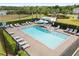 A community pool with sun loungers and umbrellas creates a relaxing outdoor space at 2431 Knoll Dr, Apopka, FL 32712