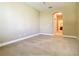 Bright, carpeted bedroom featuring an archway and an ensuite bathroom at 30732 Lipizzan Ter, Mount Dora, FL 32757