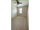 Neutral bedroom featuring tan carpet, a ceiling fan and a bright window at 30732 Lipizzan Ter, Mount Dora, FL 32757