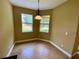 Cozy breakfast nook with two windows, a pendant light, and tile flooring at 30732 Lipizzan Ter, Mount Dora, FL 32757