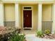 Covered front entry with columns and decorative door at 30732 Lipizzan Ter, Mount Dora, FL 32757