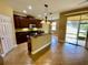 Modern kitchen with stainless steel appliances, dark wood cabinetry, and a convenient center island at 30732 Lipizzan Ter, Mount Dora, FL 32757