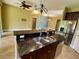 Modern kitchen with granite island countertop, stainless steel appliances, and open floor plan at 30732 Lipizzan Ter, Mount Dora, FL 32757