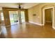 Open living room featuring tile floors, sliding glass doors, and access to the lanai at 30732 Lipizzan Ter, Mount Dora, FL 32757