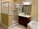 Well-appointed bathroom with a glass-enclosed shower, vanity, and tiled walls at 30732 Lipizzan Ter, Mount Dora, FL 32757