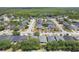 Aerial view showcasing a community of homes, tree-lined streets, and nearby lakes, creating a picturesque and desirable living environment at 3436 Gerber Daisy Ln, Oviedo, FL 32766