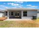 Charming back patio with brick pavers, covered area with ceiling fan, and small deck overlooking the backyard at 3436 Gerber Daisy Ln, Oviedo, FL 32766