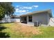 Lush green backyard featuring a well-maintained lawn and a perimeter defined by a white fence at 3436 Gerber Daisy Ln, Oviedo, FL 32766