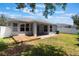 Charming backyard with a brick patio, wooden deck, air conditioning unit, and white fence at 3436 Gerber Daisy Ln, Oviedo, FL 32766