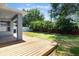 Beautiful backyard featuring a wooden deck, lush green grass, and mature trees at 3436 Gerber Daisy Ln, Oviedo, FL 32766