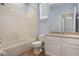 Bathroom with tiled shower and bathtub, light blue walls, and tile floors at 3436 Gerber Daisy Ln, Oviedo, FL 32766