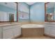 Bathroom features a large soaking tub and dual sinks at 3436 Gerber Daisy Ln, Oviedo, FL 32766