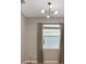 Bedroom featuring neutral walls, modern light fixture, window with curtains, and wood flooring at 3436 Gerber Daisy Ln, Oviedo, FL 32766