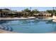 Inviting community pool with plenty of seating surrounded by mature landscaping and shade structures for relaxation at 3436 Gerber Daisy Ln, Oviedo, FL 32766