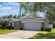 Cozy single-story home with a two-car garage, stone accents, an arched entryway and nice landscaping at 3436 Gerber Daisy Ln, Oviedo, FL 32766