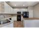 Kitchen with white cabinets, stainless steel appliances, and a center island at 3436 Gerber Daisy Ln, Oviedo, FL 32766