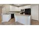 Kitchen with white cabinets, an island, granite countertops and stainless steel appliances at 3436 Gerber Daisy Ln, Oviedo, FL 32766