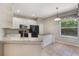 Charming kitchen with white cabinets and granite countertops at 3436 Gerber Daisy Ln, Oviedo, FL 32766