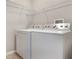 White washer and dryer setup with wire shelving at 3436 Gerber Daisy Ln, Oviedo, FL 32766