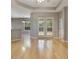 Open living space with wood floors, french doors to the backyard, modern ceiling fan and an archway at 3436 Gerber Daisy Ln, Oviedo, FL 32766