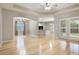 Bright living room featuring wood flooring, neutral walls, an archway and a ceiling fan at 3436 Gerber Daisy Ln, Oviedo, FL 32766