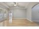 Spacious living room with tray ceilings, wood flooring, neutral walls, french doors and an archway at 3436 Gerber Daisy Ln, Oviedo, FL 32766