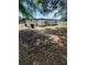 Shows backyard with leaves and grass with white house and fence in the background at 3463 Fekany Pl, Orlando, FL 32805