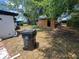 Large backyard with shed, surrounded by trees, trash bin at 3463 Fekany Pl, Orlando, FL 32805