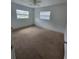 Spacious bedroom features cozy carpet flooring and two windows providing ample light at 3463 Fekany Pl, Orlando, FL 32805