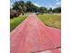Wide driveway leading to a charming home in a quiet neighborhood, surrounded by lush green lawns at 3463 Fekany Pl, Orlando, FL 32805