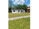 Shows the front exterior of a single story house with white exterior and a small front yard at 3463 Fekany Pl, Orlando, FL 32805