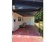 Inviting front porch with a covered area, featuring a red concrete patio and seating, offering curb appeal at 3463 Fekany Pl, Orlando, FL 32805