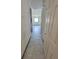 Hallway leads to a bright room with a window and ceiling fan at 3463 Fekany Pl, Orlando, FL 32805