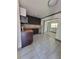 Kitchen with stainless steel appliances, tile floors, and dark cabinetry at 3463 Fekany Pl, Orlando, FL 32805