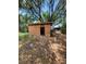 Image shows unfinished shed with plywood walls and open doorway in grassy, wooded yard at 3463 Fekany Pl, Orlando, FL 32805