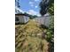 Shows side yard with grass and a white fence and part of house with black trim at 3463 Fekany Pl, Orlando, FL 32805