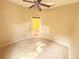 This is a light and airy bedroom with neutral carpet and a ceiling fan at 402 Ravenshill Way, Deland, FL 32724