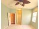 Bright bedroom with a neutral carpet, ceiling fan, and natural light from the window at 402 Ravenshill Way, Deland, FL 32724