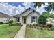 Charming single-story home featuring a well-manicured lawn and lush landscaping at 402 Ravenshill Way, Deland, FL 32724