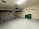 Spacious garage with painted walls, ample space for storage, and an automatic door at 402 Ravenshill Way, Deland, FL 32724