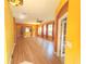 Open-concept living area featuring wood floors, ample light and neutral color palette at 402 Ravenshill Way, Deland, FL 32724