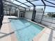 Screened in pool with deck and partial house view at 402 Ravenshill Way, Deland, FL 32724